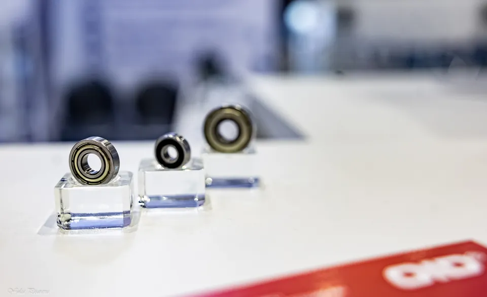Three small bearings on clear display stands