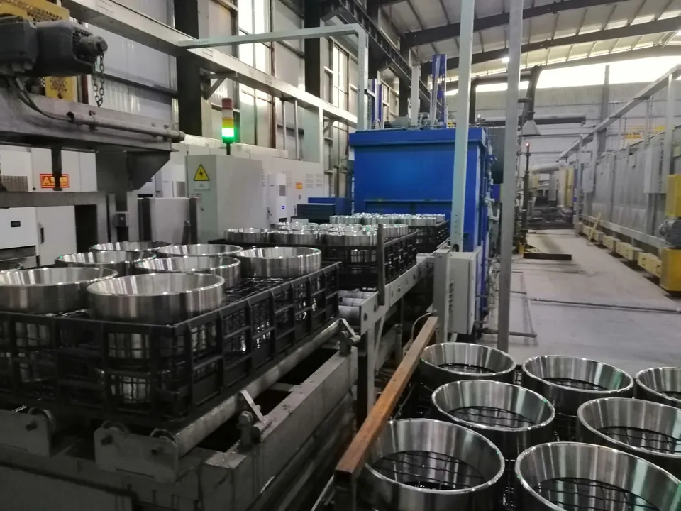 Rows of machined rings next to production equipment