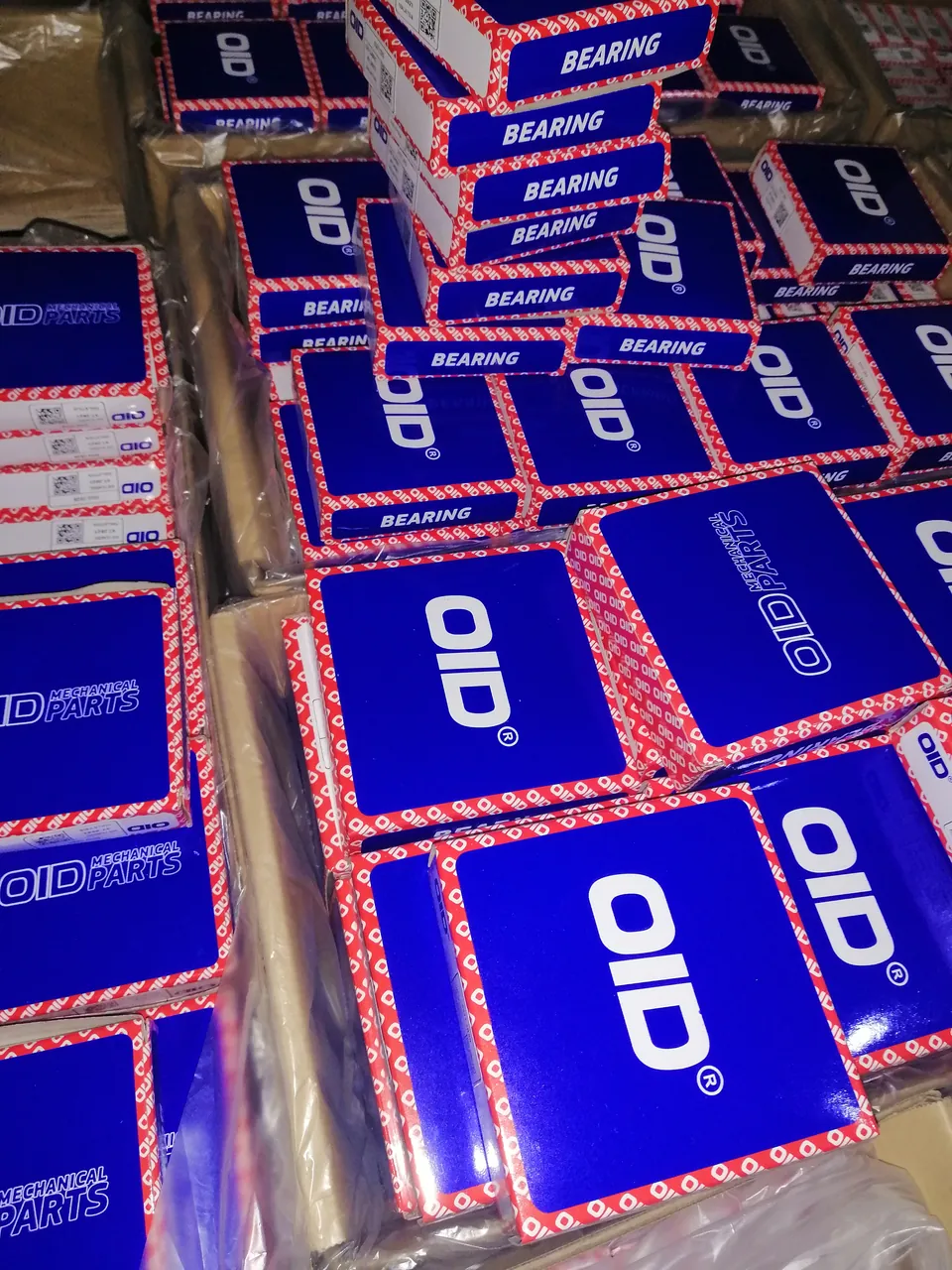 Blue boxes marked with the OID logo, prepared for packaging