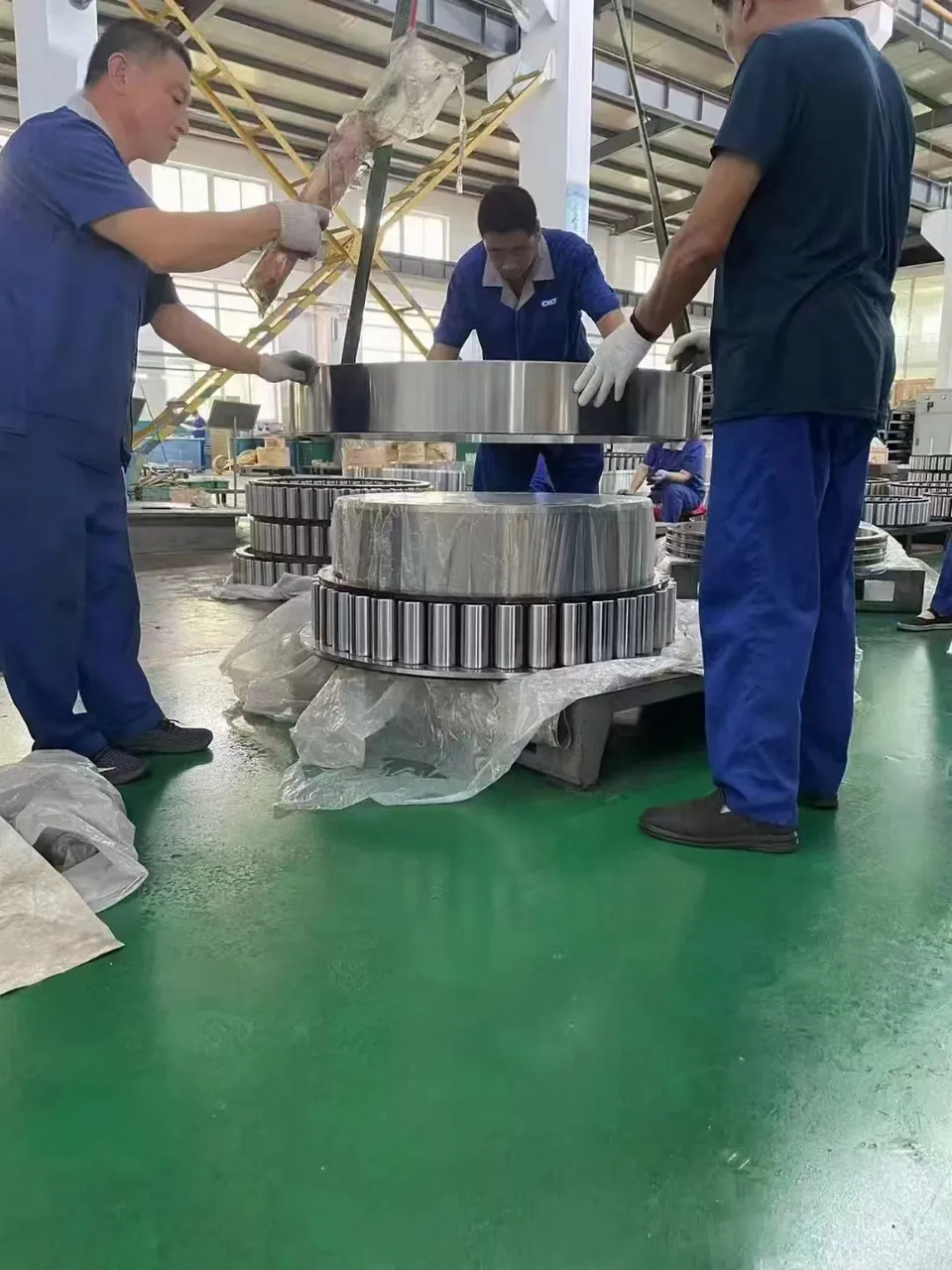 Specialists working with a large ring product in the shop